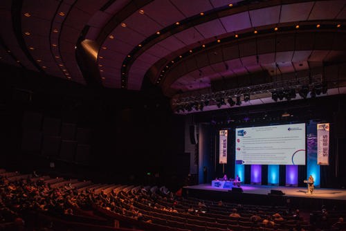 Wide shot image of a session taking place at the main auditorium at the Harrogate Convention Centre.